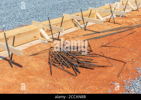 Horizontal shot of wooden framing and iron rods in preparation for concrete to be poured for the foundation. Stock Photo