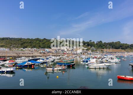 Sailing and motor boats moored at the Cobb in Lyme Regis, a popular seaside town holiday resort on the Jurassic Coast in Dorset, south-west England Stock Photo