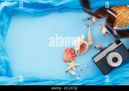 Top view composition - Blank paper photo frames with starfish, shells and items on wooden table. Concept of remembrance and nostalgia in summer touris Stock Photo