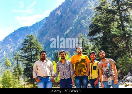 Travellers in the green mountains enjoying the natural beauty of our earth. Top of Triund Peak. Trekking in the Himalaya mountains. Landscape - Image Stock Photo