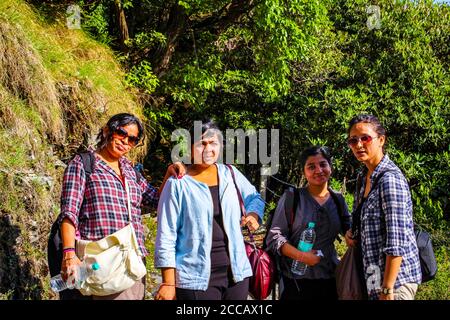 Travellers in the green mountains enjoying the natural beauty of our earth. Top of Triund Peak. Trekking in the Himalaya mountains. Landscape - Image Stock Photo