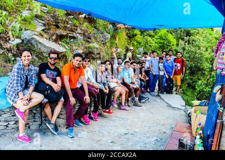 Travellers in the green mountains enjoying the natural beauty of our earth. Top of Triund Peak. Trekking in the Himalaya mountains. Landscape - Image Stock Photo