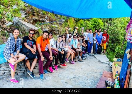 Travellers in the green mountains enjoying the natural beauty of our earth. Top of Triund Peak. Trekking in the Himalaya mountains. Landscape - Image Stock Photo