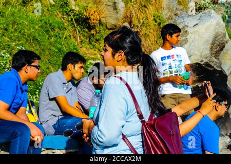 Travellers in the green mountains enjoying the natural beauty of our earth. Top of Triund Peak. Trekking in the Himalaya mountains. Landscape - Image Stock Photo