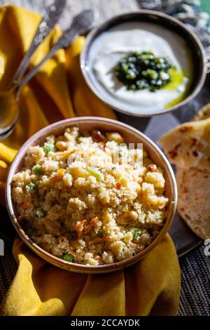 South Indian breakfast savory vegetable semolina porridge Rava Upma with green mint chutney and paratha.Authentic vegetarian food still life. Stock Photo