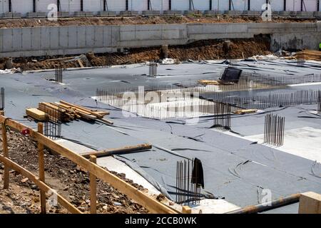 Foundations for a new building with reinforcing mesh and concrete on a construction site. Stock Photo