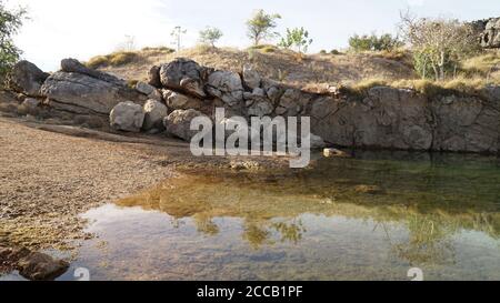 Pond lake situated in lush landscape at Boab Quarry Campsite in Western Australia. Stock Photo