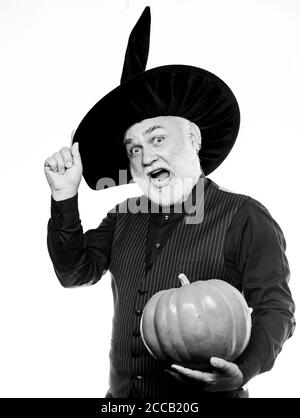Experienced and wise. Halloween tradition. Cosplay outfit. Senior man white beard celebrate Halloween with pumpkin. Wizard costume hat Halloween party. Magician witcher old man. Magic concept. Stock Photo