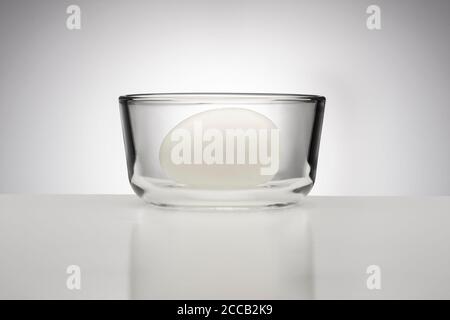 Hard boiled egg in clear glass bowl Stock Photo