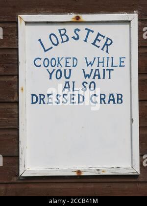 A simple sign advertises lobster cooked while you wait, also dressed crab, in the fishing village of Crail in north-east Fife. Stock Photo