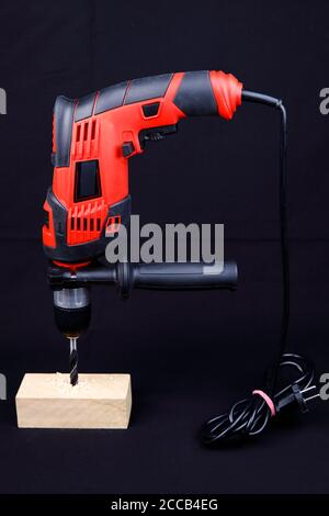 An electric drill isolated on black background Stock Photo