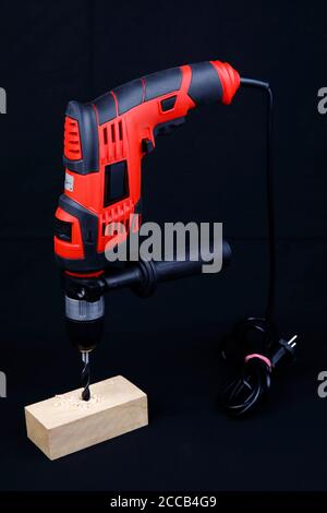 An electric drill isolated on black background Stock Photo