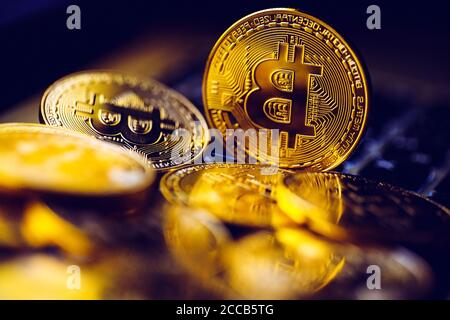 Bitcoin coins on laptop keyboard. Cryptocurrency background. Stock Photo