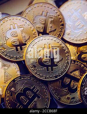 Bitcoin coins on laptop keyboard. Cryptocurrency background. Stock Photo