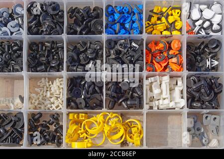 Various small plastic car parts for interior in box Stock Photo
