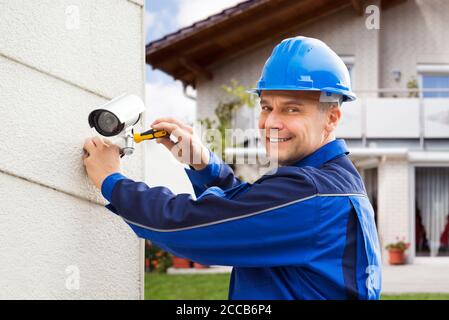 CCTV Security Camera Technician Professional And Electrician Stock Photo