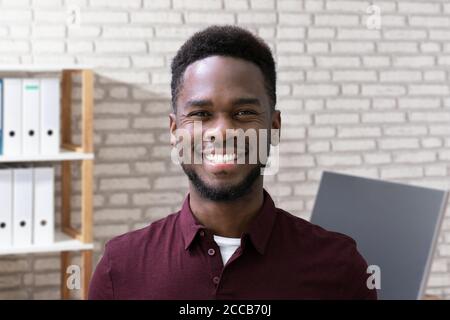 Smiling Man Portrait At Workplace In Office Stock Photo