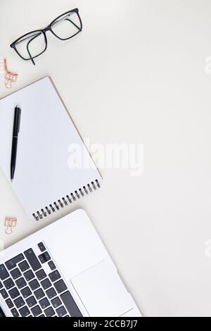 light office desk with laptop, white notebook mockup and glasses  Stock Photo
