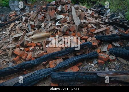 Heap of broken old red brick close-up. Red brick texture folded and laid out in one plane. Stock Photo