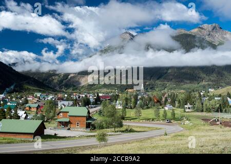 View of the town of Silverton, Colorado nestled in a valley in the San Juan Mountains with Sultan Mountain in the distance Stock Photo