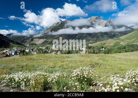 View of the town of Silverton, Colorado nestled in a valley in the San Juan Mountains with Sultan Mountain in the distance Stock Photo