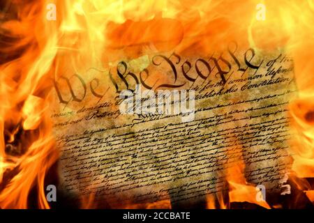 close up of United States constitution document burning in flames Stock Photo