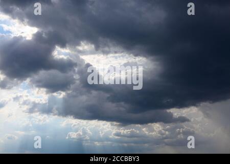 Hole in the sky . Black clouds with sunshine Stock Photo