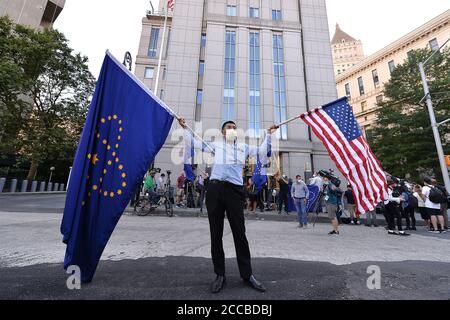 New York, USA. 20th Aug, 2020. A Steve Bannon supporter hold up two flags as he waits for the former adviser to President Donald J. Trump, to walk out of a Manhattan Federal Court in New York, NY on August 20, 2020. Bannon was brought in on charges of conspiracy to commit fraud in connection to his We Build the Wall fundraising campaign that was to help build a border wall between the United States and Mexico. Bannon was released on bail with a $5 millon dollar bond after pleading not guilty. (Photo by Anthony Behar/Sipa USA) Credit: Sipa USA/Alamy Live News Stock Photo