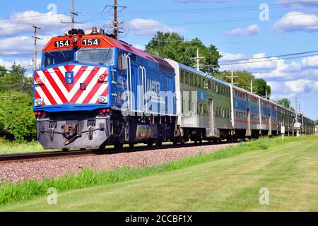 Geneva, Illinois, USA. A Metra locomotive pushing its commuter train destined for Chicago through Geneva, Illinois.