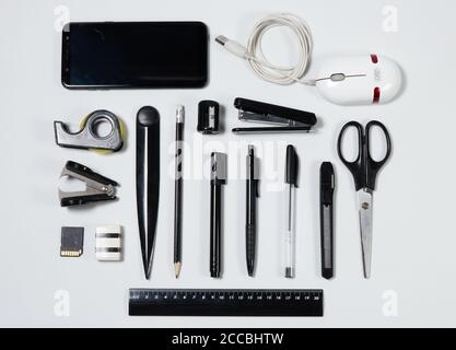 Office items and business elements on a desk like ruler, pen, pencil, eraser, pencil sharpener, notepad, letter opener, paper clips, scissors, stapler Stock Photo