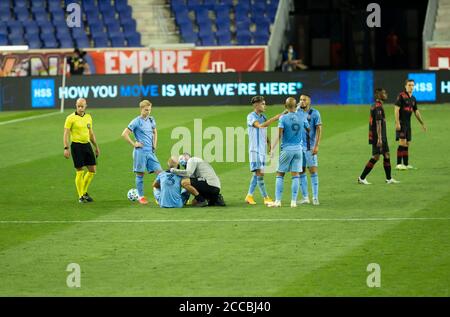 Harrison, United States. 20th Aug, 2020. NYCFC doctor wearing facial mask attends injured Anton Tinnerholm (3) during MLS regular season game between Red Bulls and NYCFC in Harrison, New Jersey on August 20, 2020. Game was played without fans because of COVID-19 pandemic precaution. Red Bulls won 1 - 0. (Photo by Lev Radin/Sipa USA) Credit: Sipa USA/Alamy Live News Stock Photo