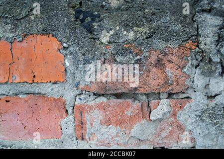 red brick wall. cracked bricks. bricks texture. curved dirty Stock Photo