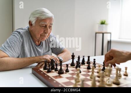 Elderly Senior Playing Chess Table Board Game Stock Photo