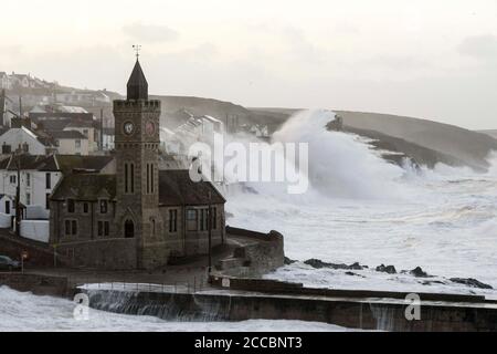 Porthleven, Cornwall, UK.  21st August 2020.  UK Weather.  Huge waves from Storm Ellen smash into the cliffs and coastal defences at Porthleven in Cornwall at sunrise during high tide on a morning of gale force winds from Storm Ellen.  Picture Credit: Graham Hunt/Alamy Live News Stock Photo