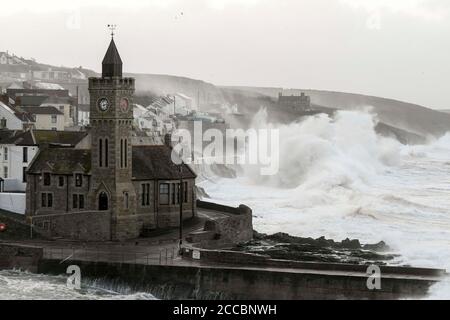 Porthleven, Cornwall, UK.  21st August 2020.  UK Weather.  Huge waves from Storm Ellen smash into the cliffs and coastal defences at Porthleven in Cornwall at sunrise during high tide on a morning of gale force winds from Storm Ellen.  Picture Credit: Graham Hunt/Alamy Live News Stock Photo