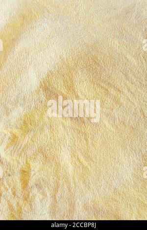 Texture of natural yellow textile fabric. Canvas material. Stock Photo