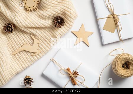 Vintage wooden Christmas decorations and gift boxes on white background. Christmas eco decor concept. Flat lay, top view. Stock Photo