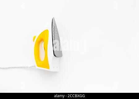 Top view of yellow iron on ironin board Stock Photo
