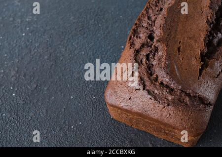 Freshly baked homemade chocolate bread or cake on dark background, rustic style. Stock Photo