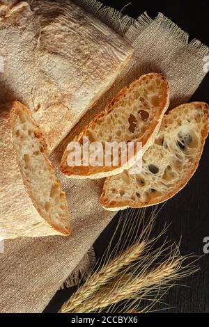Ciabatta. Fresh italian ciabatta bread with herbs, wheat ears, copy space. Stock Photo