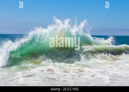 White water spray and sand being pulled up from the bottom by  a breaking wave at the famous surfing spot cylinders. Newport Beach, California; USA Stock Photo
