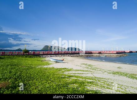 small boat on white sand  beach under clear blue sky in summer time Stock Photo