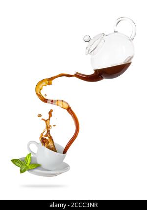 Porcelaine white cup with splashing tea from jug, separated on white background. Hot drink with splash, beverages and refreshment. Very high resolutio Stock Photo