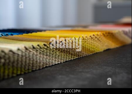 Folded gradient colored samples of luxury velvet placed on a table Stock Photo