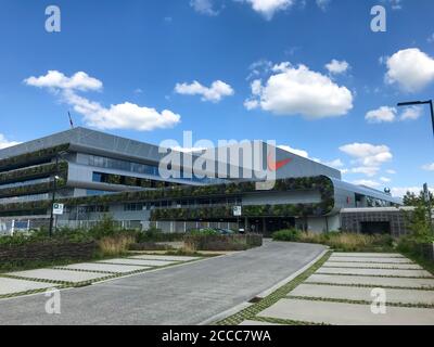 HAM, BELGIUM - February 2020: Nike's newest EMEA distribution center, Court, with a large green exterior Stock Photo