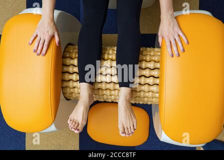 https://l450v.alamy.com/450v/2ccc8tf/woman-making-massage-for-leg-fits-roll-massage-machine-is-a-way-to-shape-the-figure-skin-care-body-care-concept-modern-relax-massage-equipment-2ccc8tf.jpg
