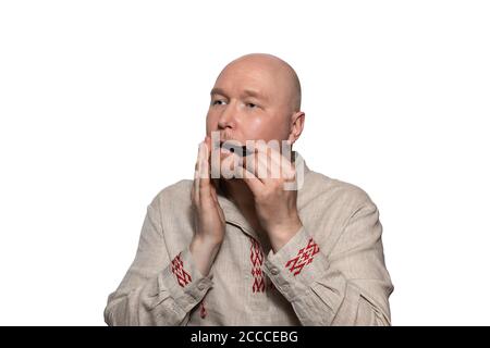 A man in national dress plays the Jew's harp Stock Photo