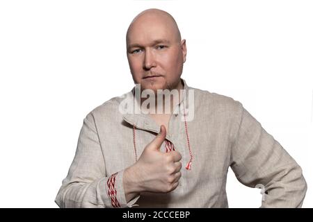 Severe man in national dress shows thumb up Stock Photo