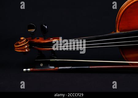 Details of a violin with bow on black background Stock Photo