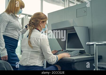 Two security officers working with X-ray machine Stock Photo